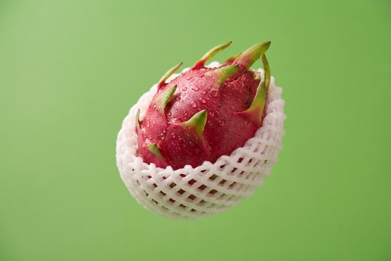 Red Pitaya sliced showing white flesh with edible black seeds