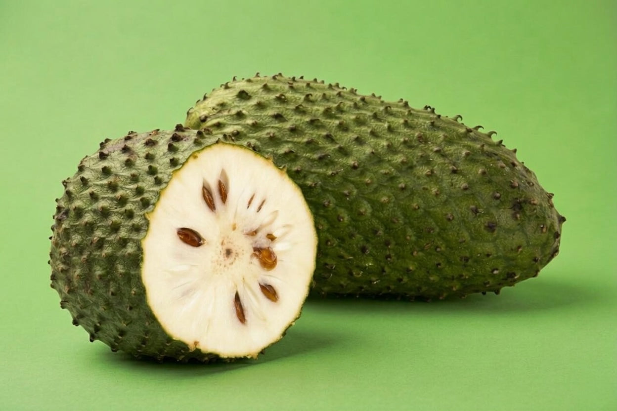 Soursop cut open showing creamy white flesh and seeds, fresh guanabana Toronto fruit delivery
